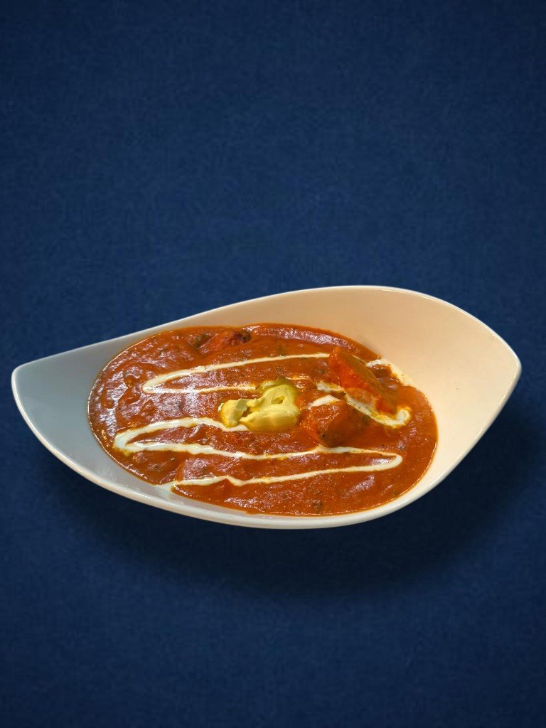 Creamy tomato curry in a white serving dish
