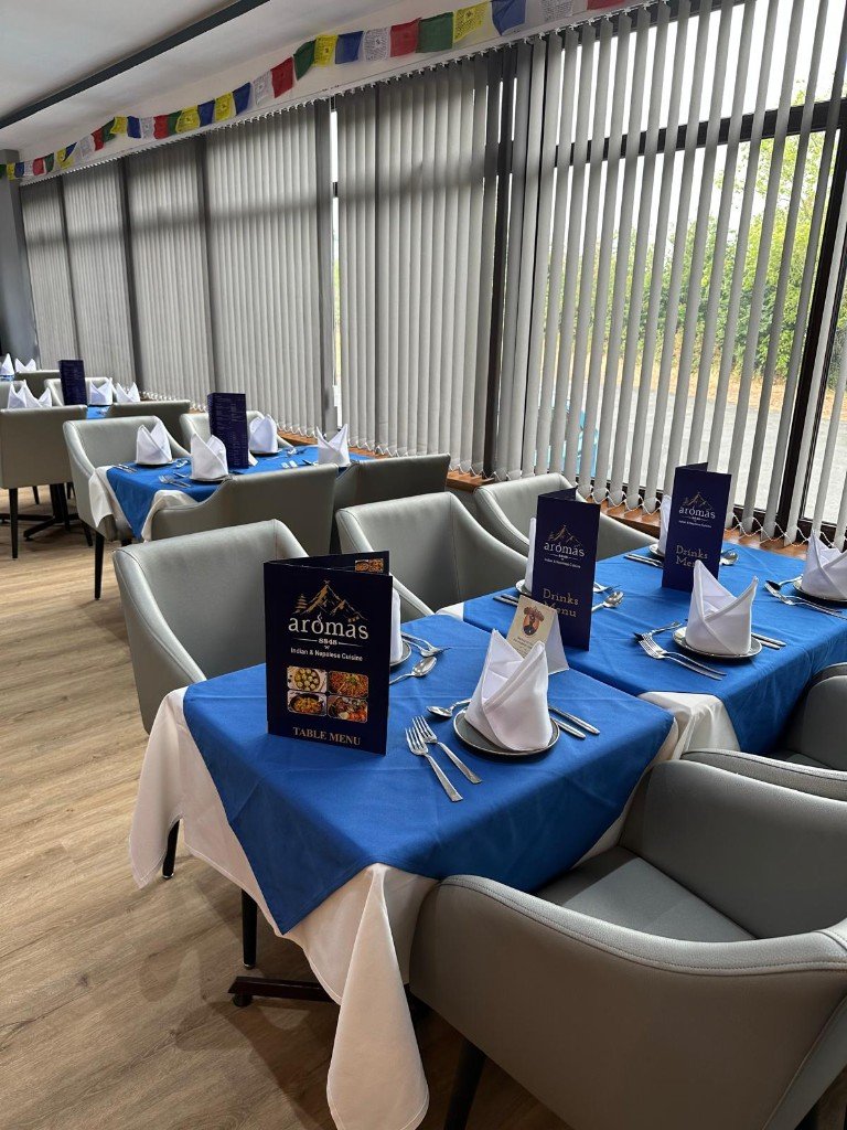A table set with blue linen and the restaurant menus